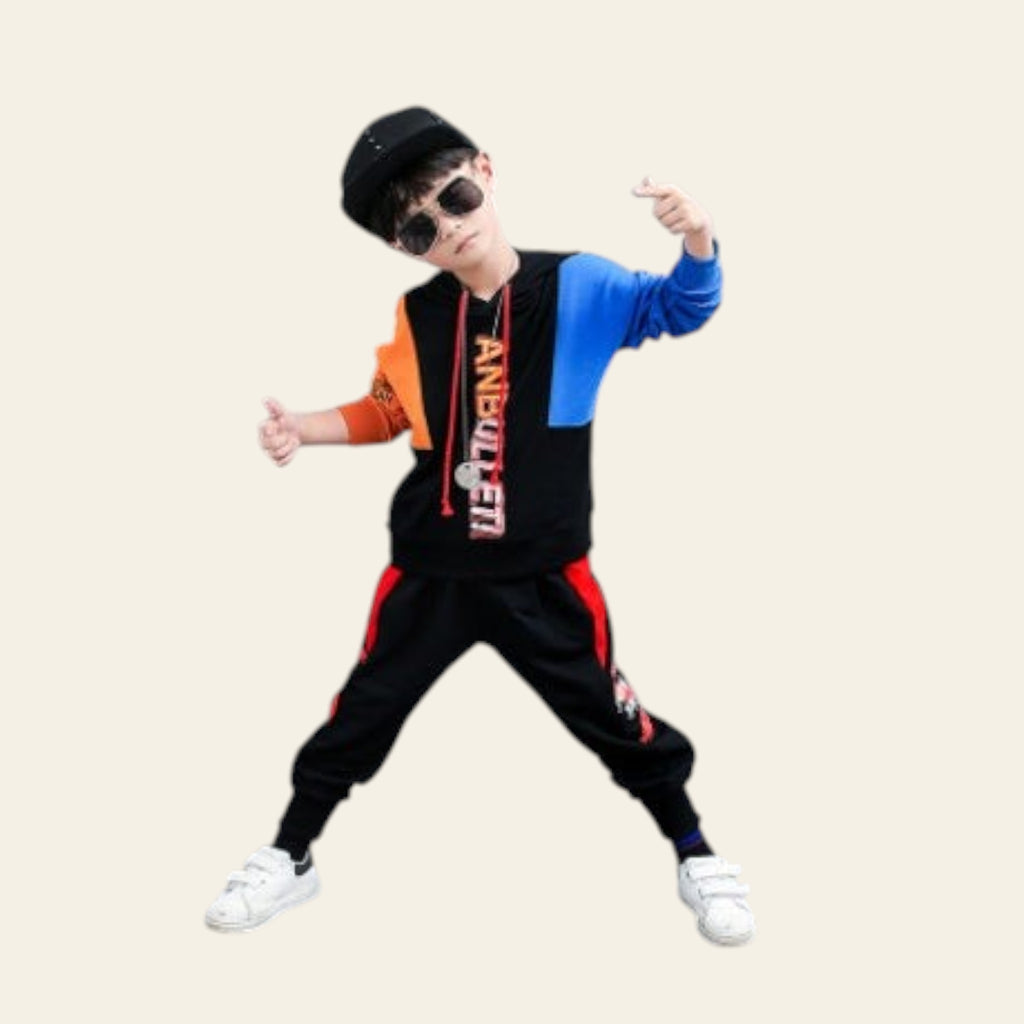 Child in a stylish outfit with a black cap, sunglasses, and colorful jacket posing against a gray background with text.