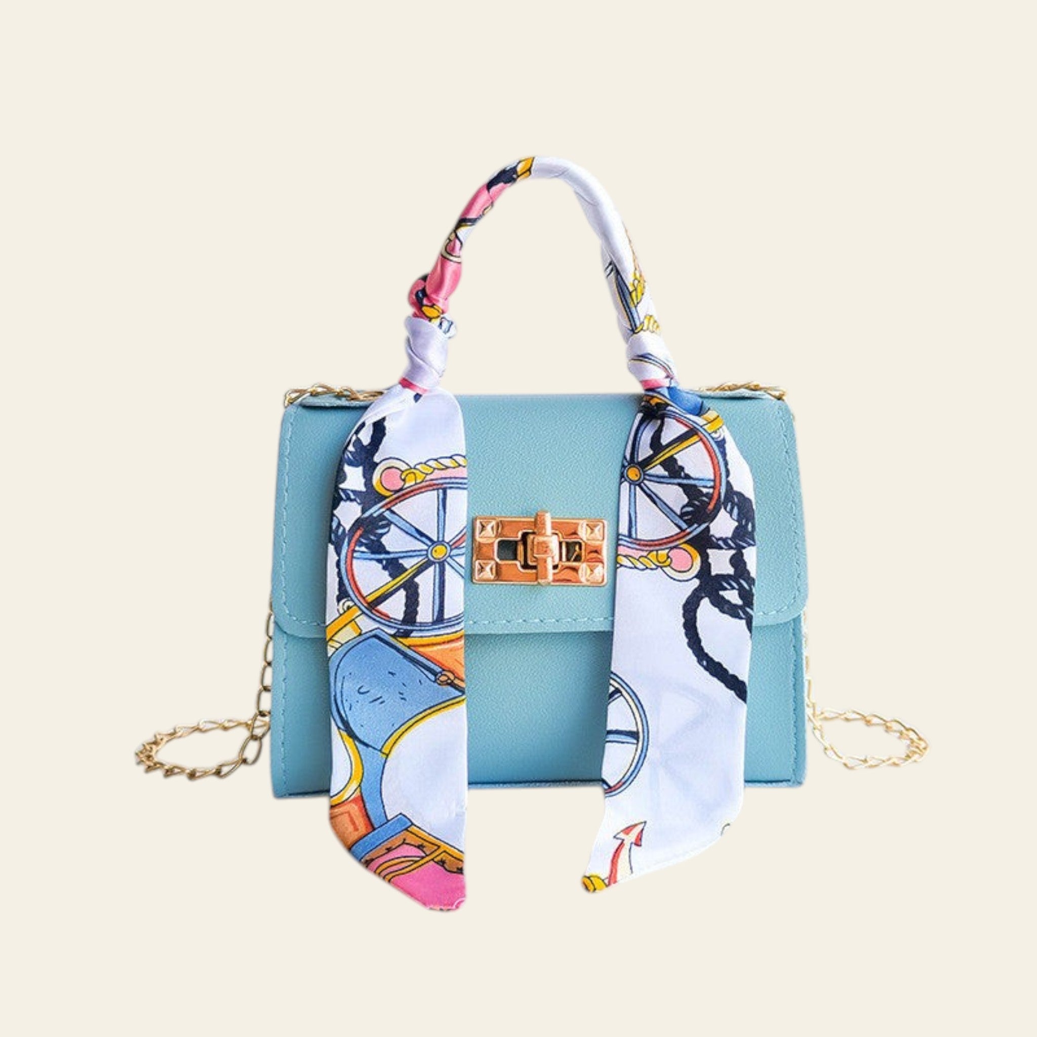 Light blue handbag with a colorful scarf draped over it on a light gray background