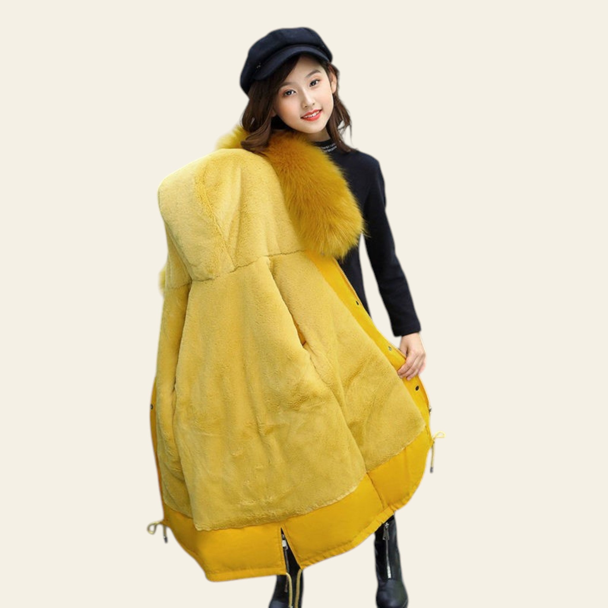 Person wearing a yellow coat with fur trim on a street.