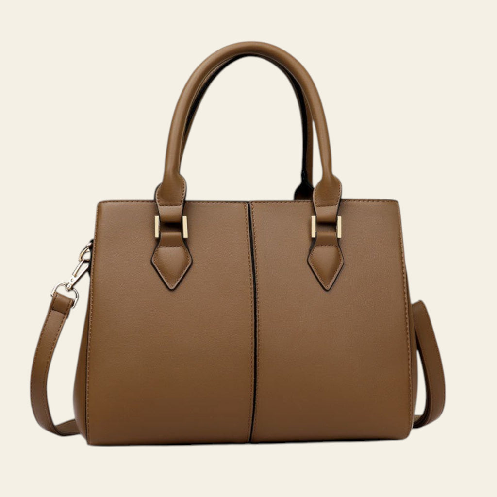 Brown handbag with gold accents on a light background