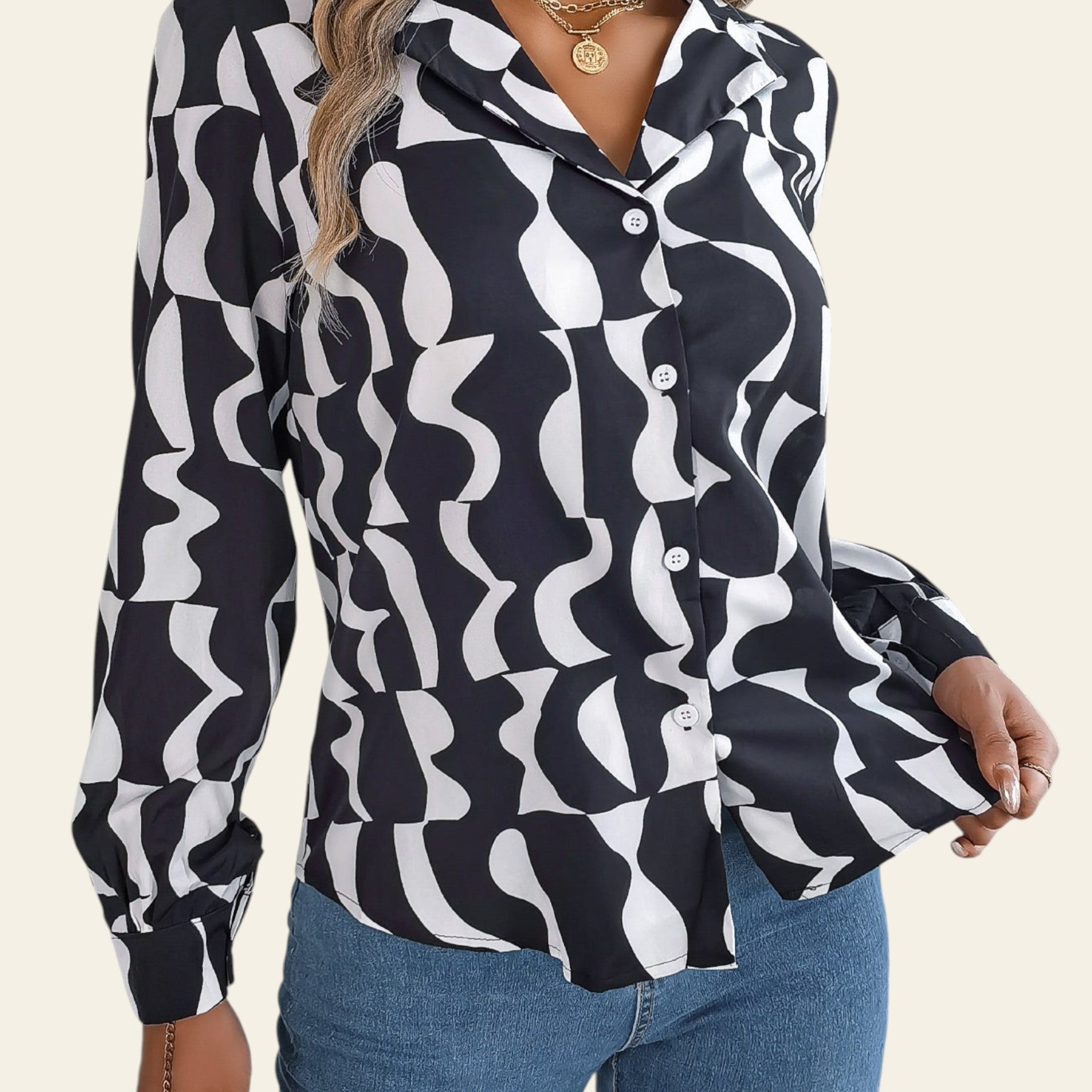 Person wearing a black and white patterned shirt with blue jeans on a neutral background