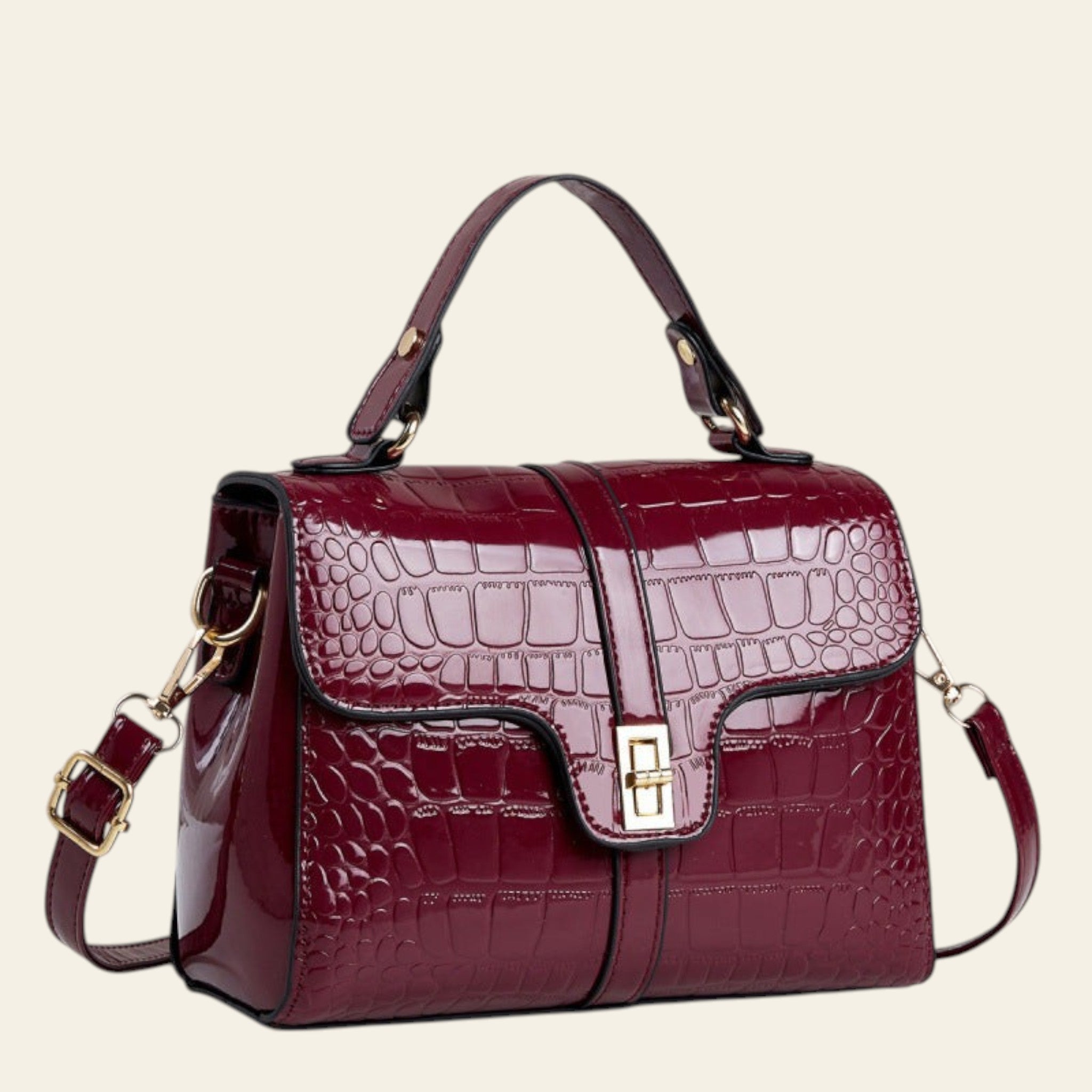 Maroon handbag with gold accents on a light gray background