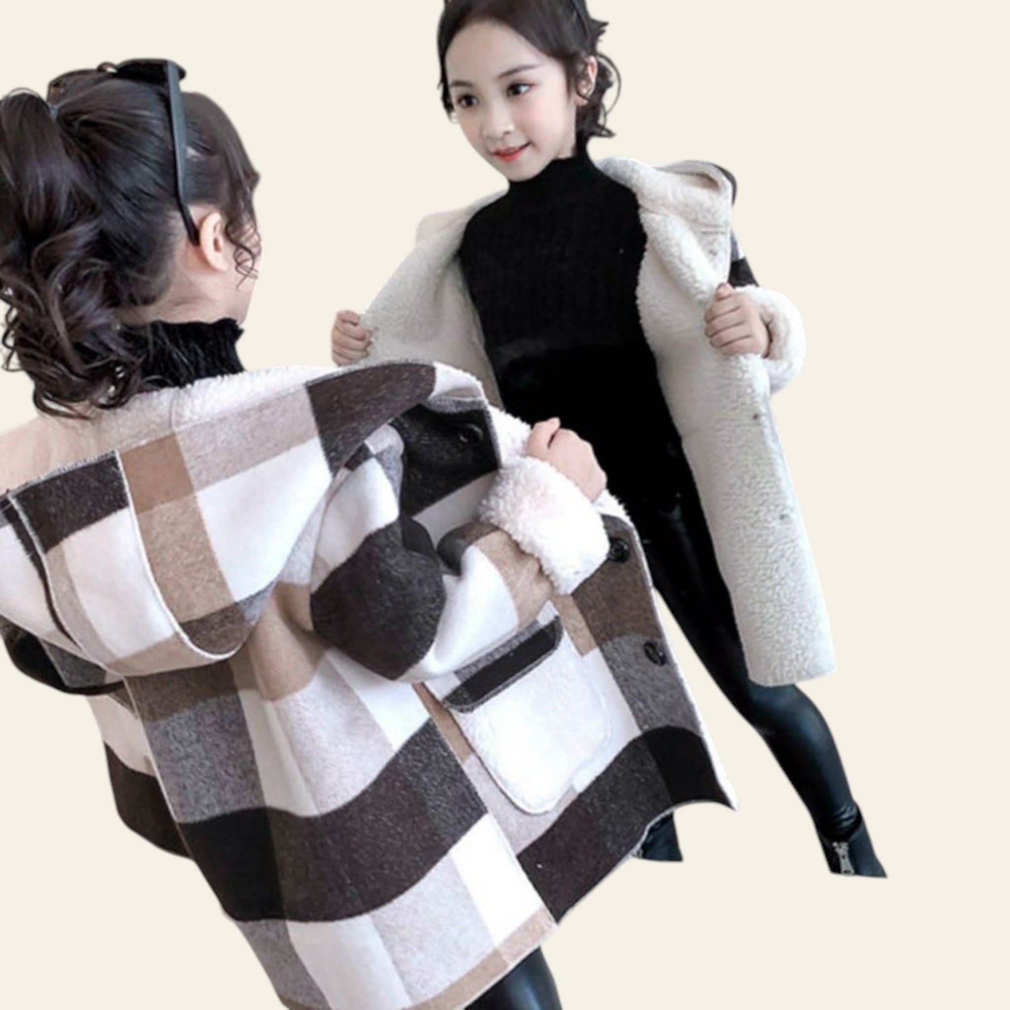 Woman trying on a plaid coat in front of a mirror.