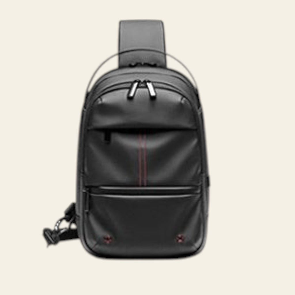 Black backpack with a strap on a white background