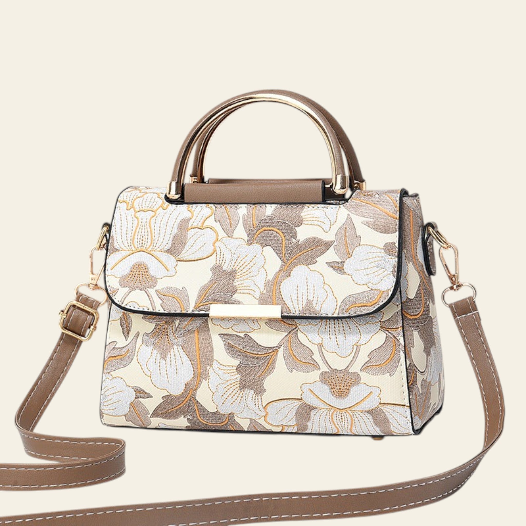 Floral patterned handbag with gold accents on a light background