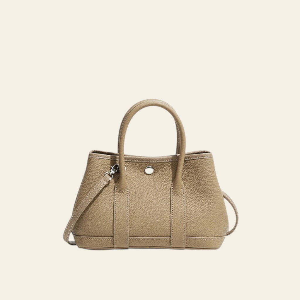Beige handbag with a strap on a white background