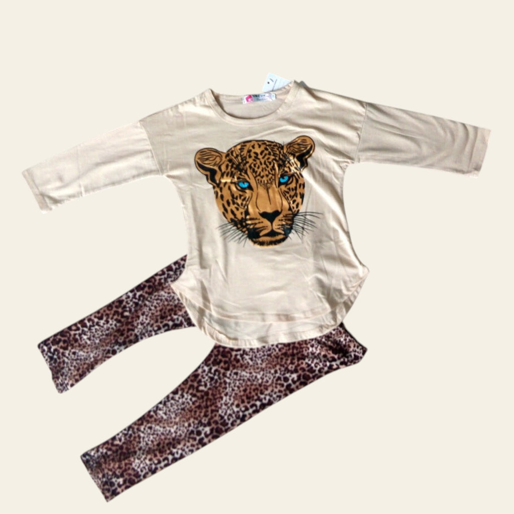 Beige long-sleeve shirt with leopard graphic and matching pants on a gray surface with decorative flowers.