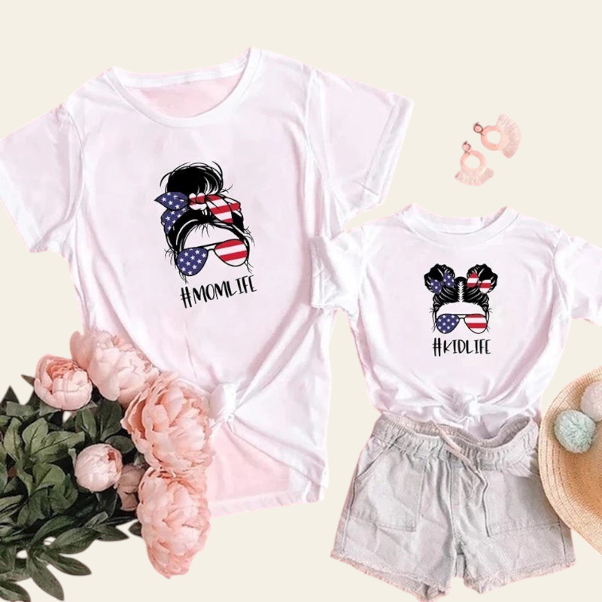 Two white t-shirts with '#MOMLIFE' and '#KIDLIFE' designs on a pink background with flowers and shorts.