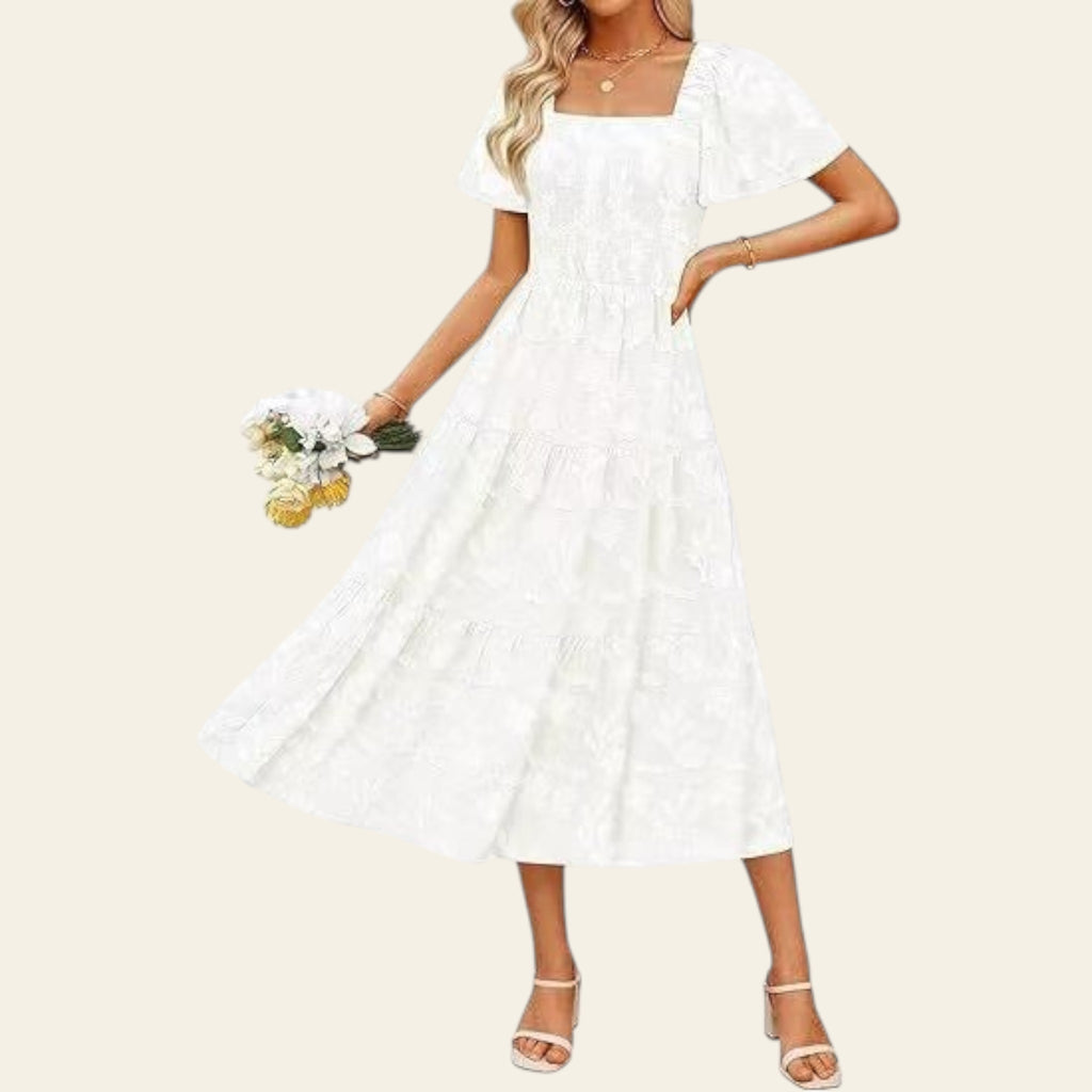 Woman wearing a white dress holding flowers on a white background