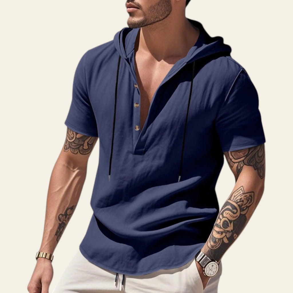 Man wearing a navy blue breathable linen hooded short sleeve henley shirt at the beach