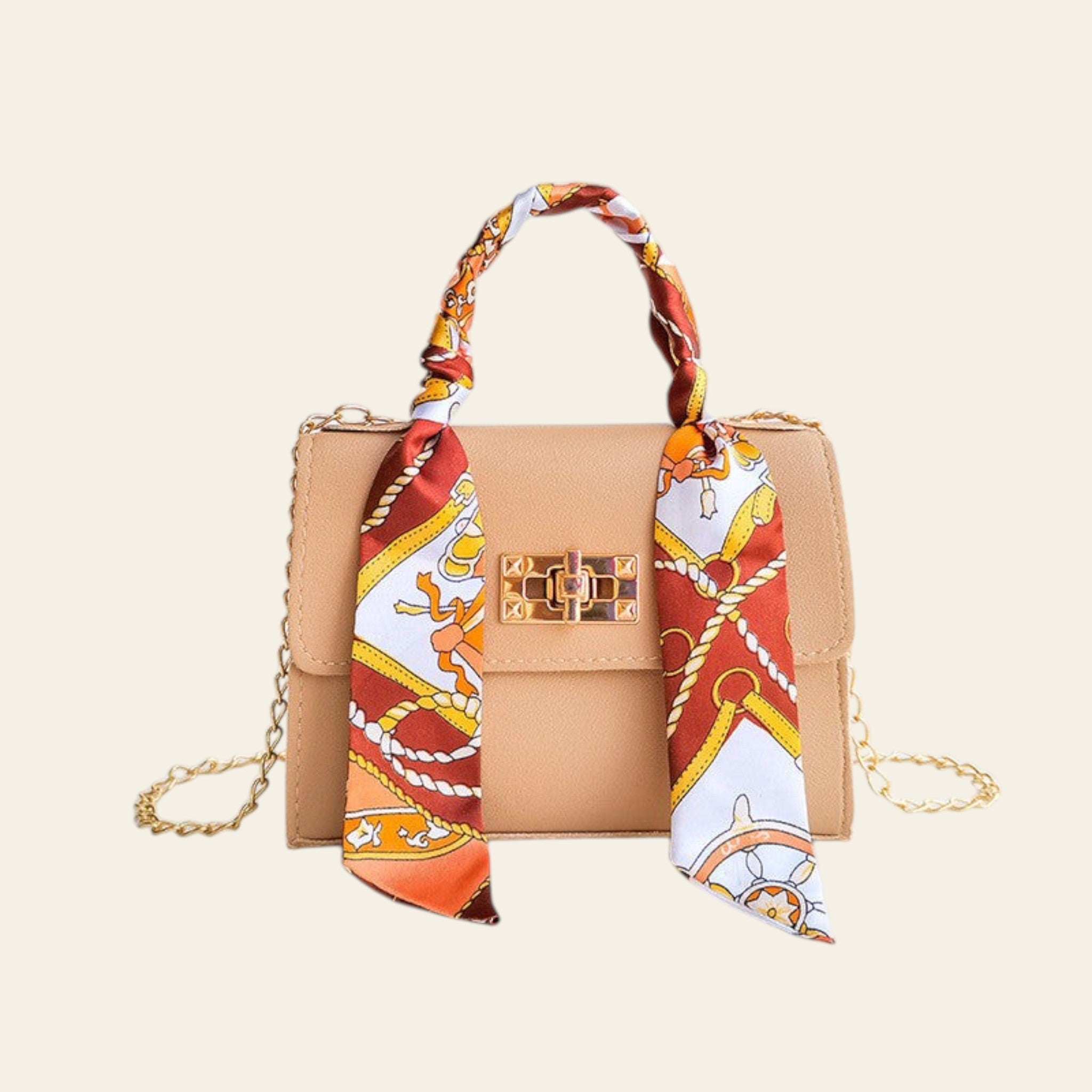 Beige handbag with a decorative scarf on a light blue background