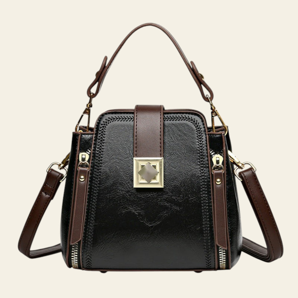 Black handbag with brown straps on a white background