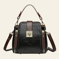 Black handbag with brown straps on a white background
