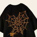 Black cape with gold spider web and spider design on a textured background