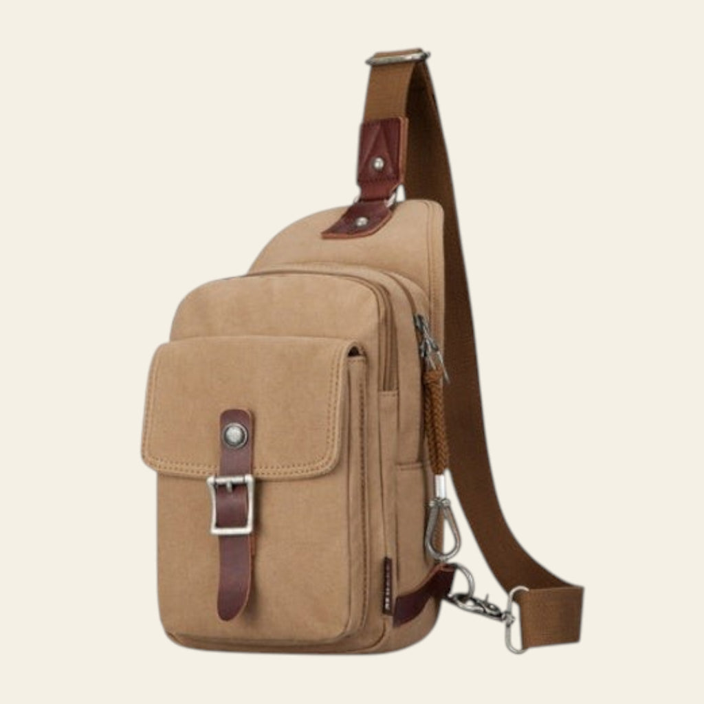 Beige sling bag with brown leather accents on a white background
