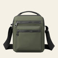 Green backpack with multiple pockets and zippers on a white background