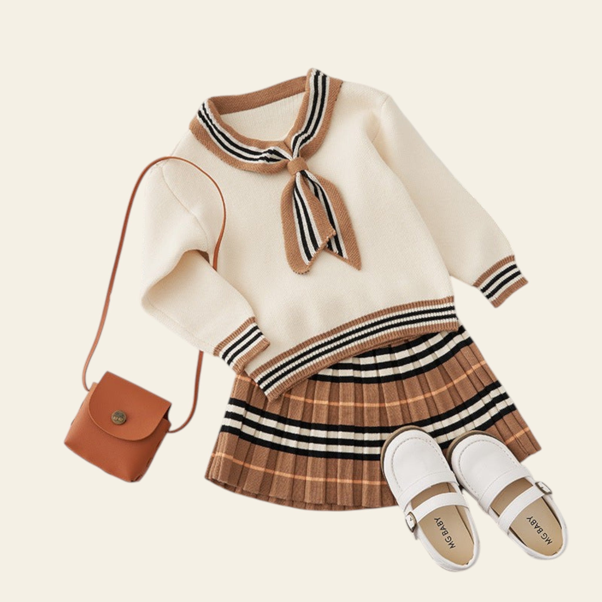 Children's outfit with sweater, skirt, shoes, and handbag on a textured surface.