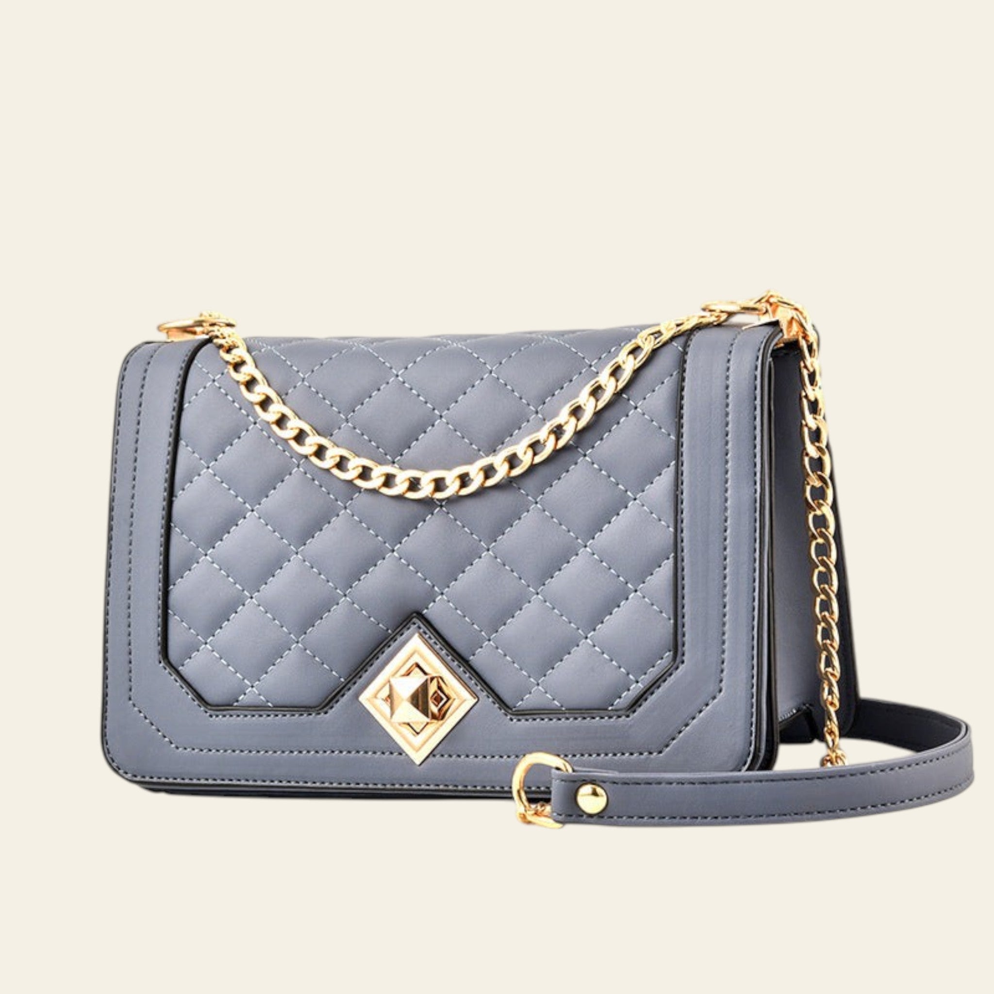 Gray quilted handbag with gold chain strap on a white background