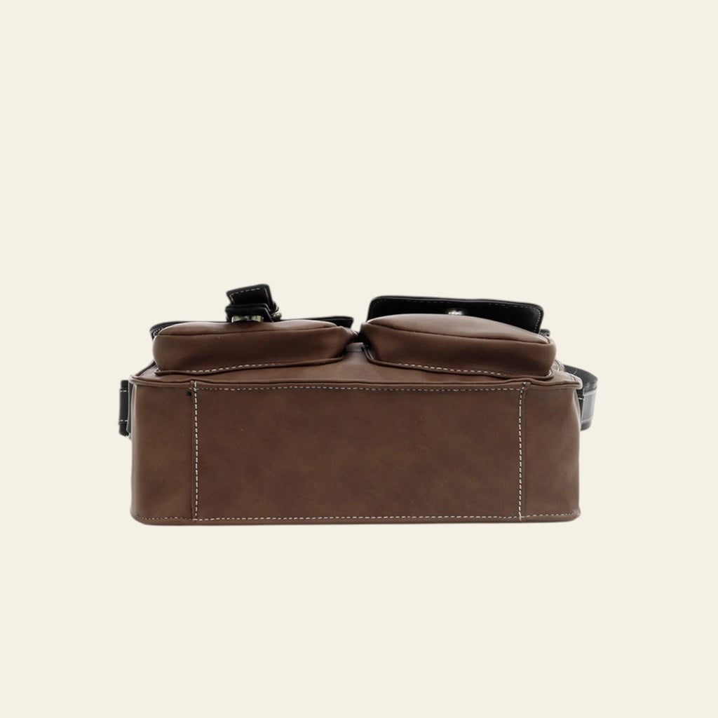 Brown leather bag with a strap on a white background