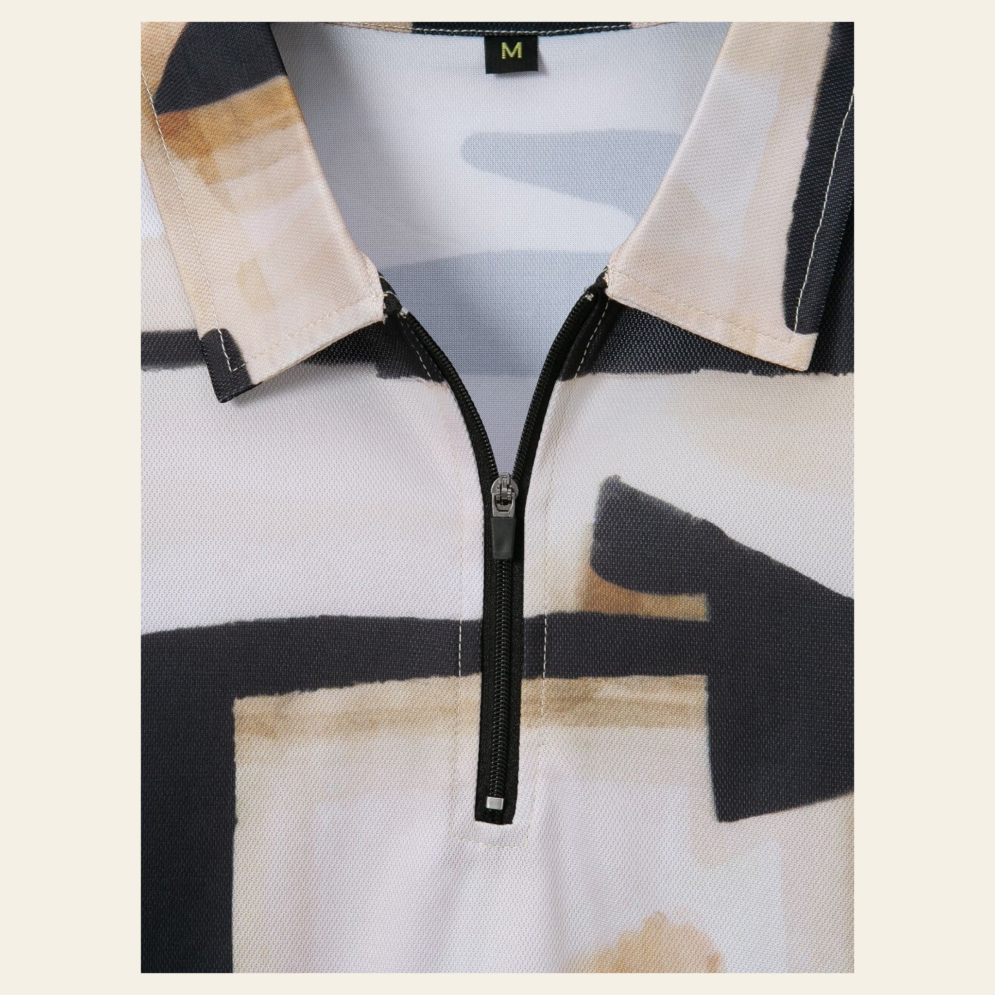 Close-up of men's patterned short-sleeve shirt showing zipper detail and textured fabric design