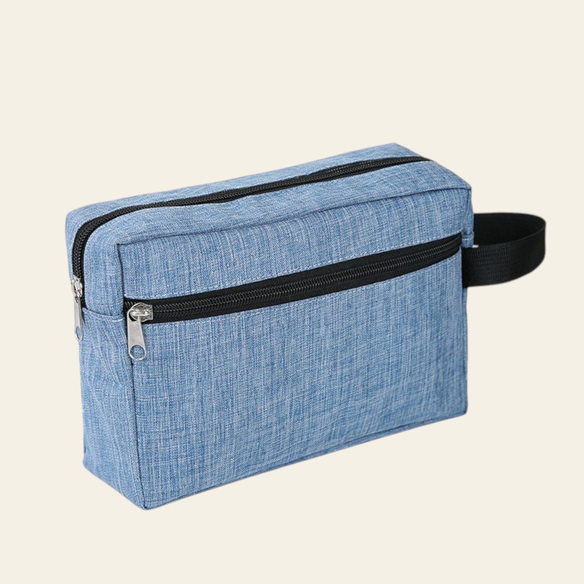 Blue textured toiletry bag with black zippers on a white background