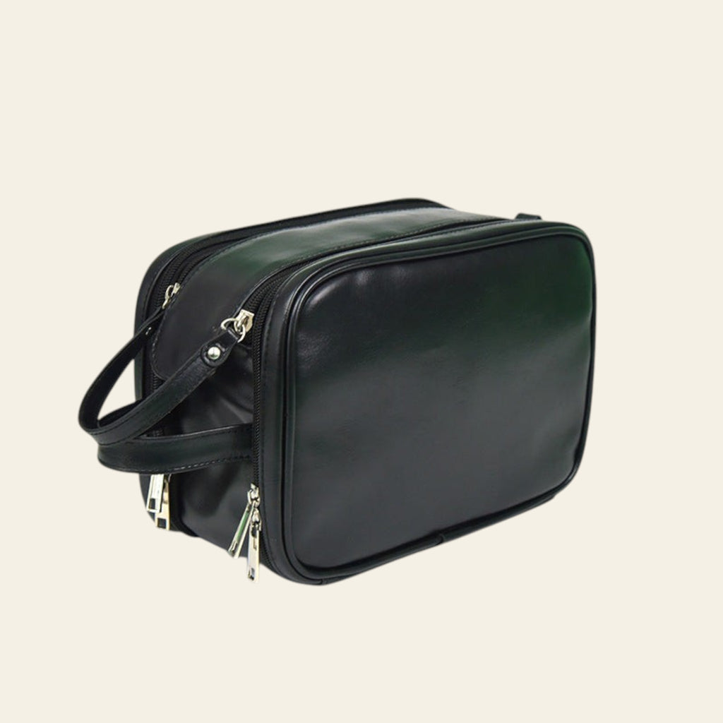 Black leather bag with gold zippers on a white background