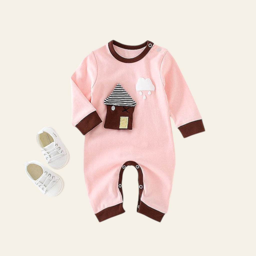 Pink baby romper with brown accents on a white surface