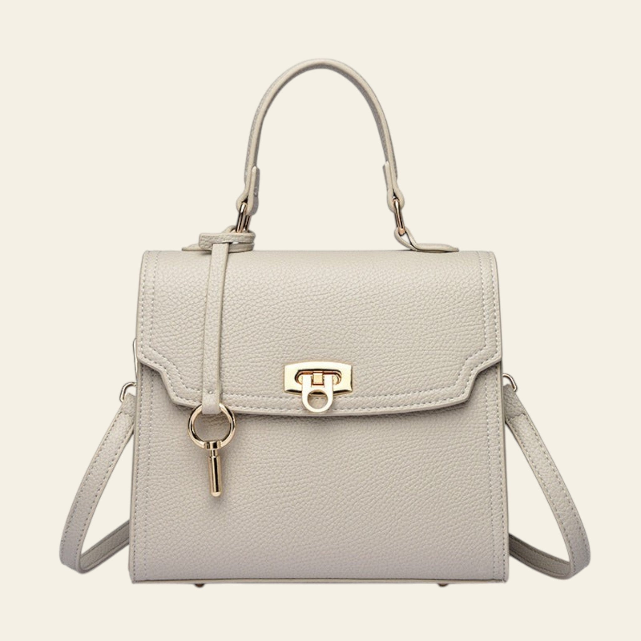 Light gray handbag with a gold clasp on a white background