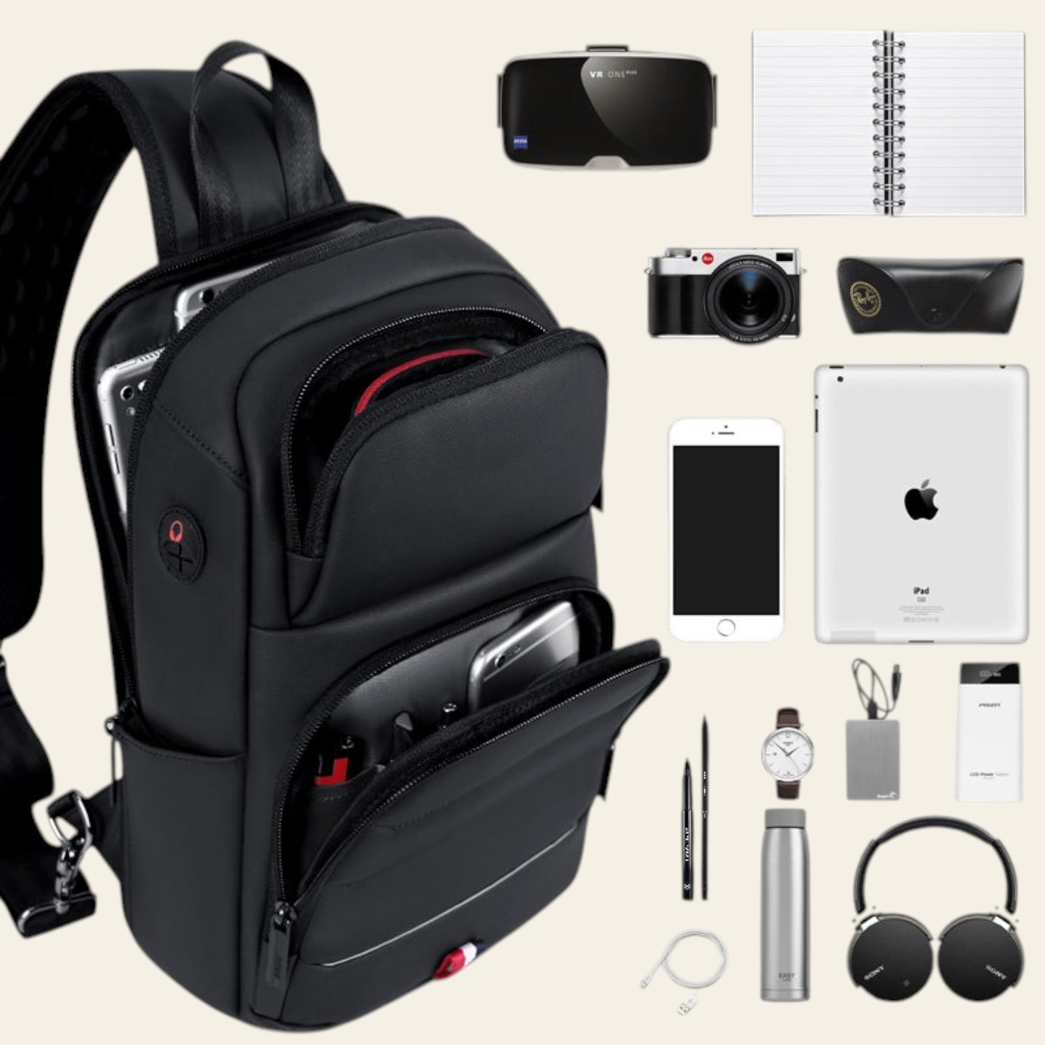 Black backpack with its compartments open, displaying various items on a light gray background.