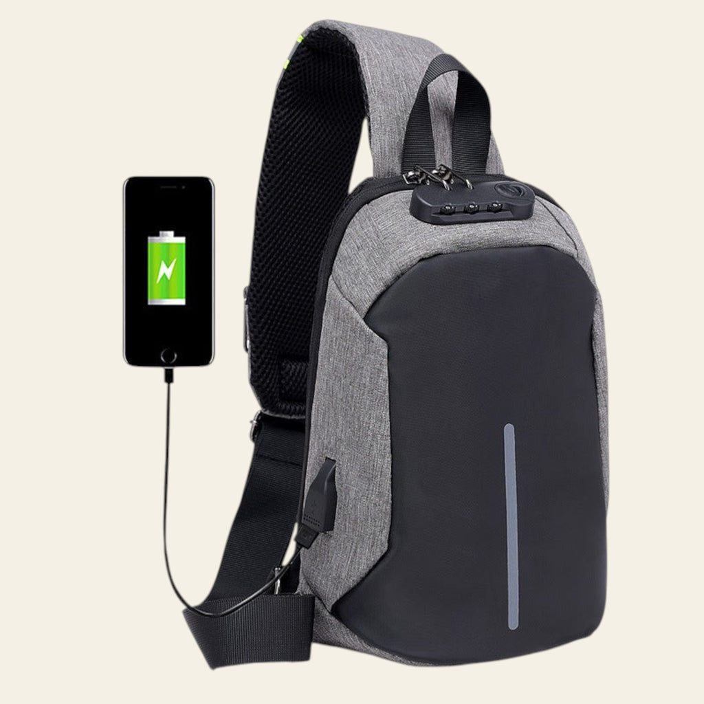 Gray and black crossbody bag with USB charging port and smartphone showing charging icon.