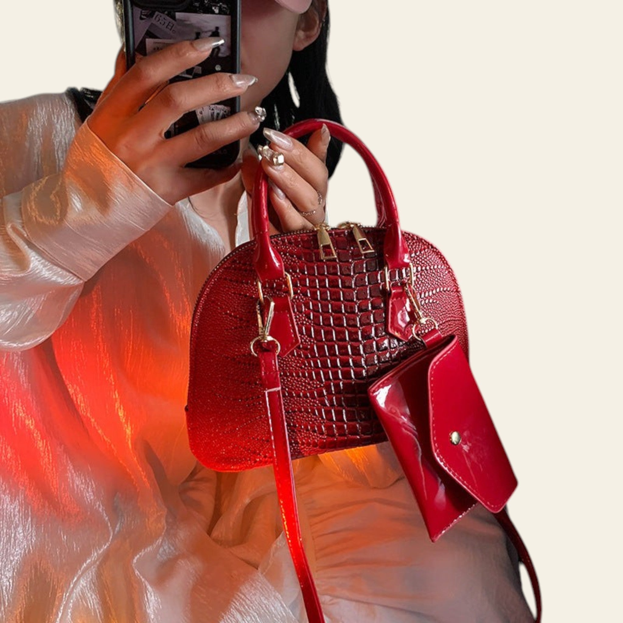 Red textured leather handbag with structured shape and crossbody strap