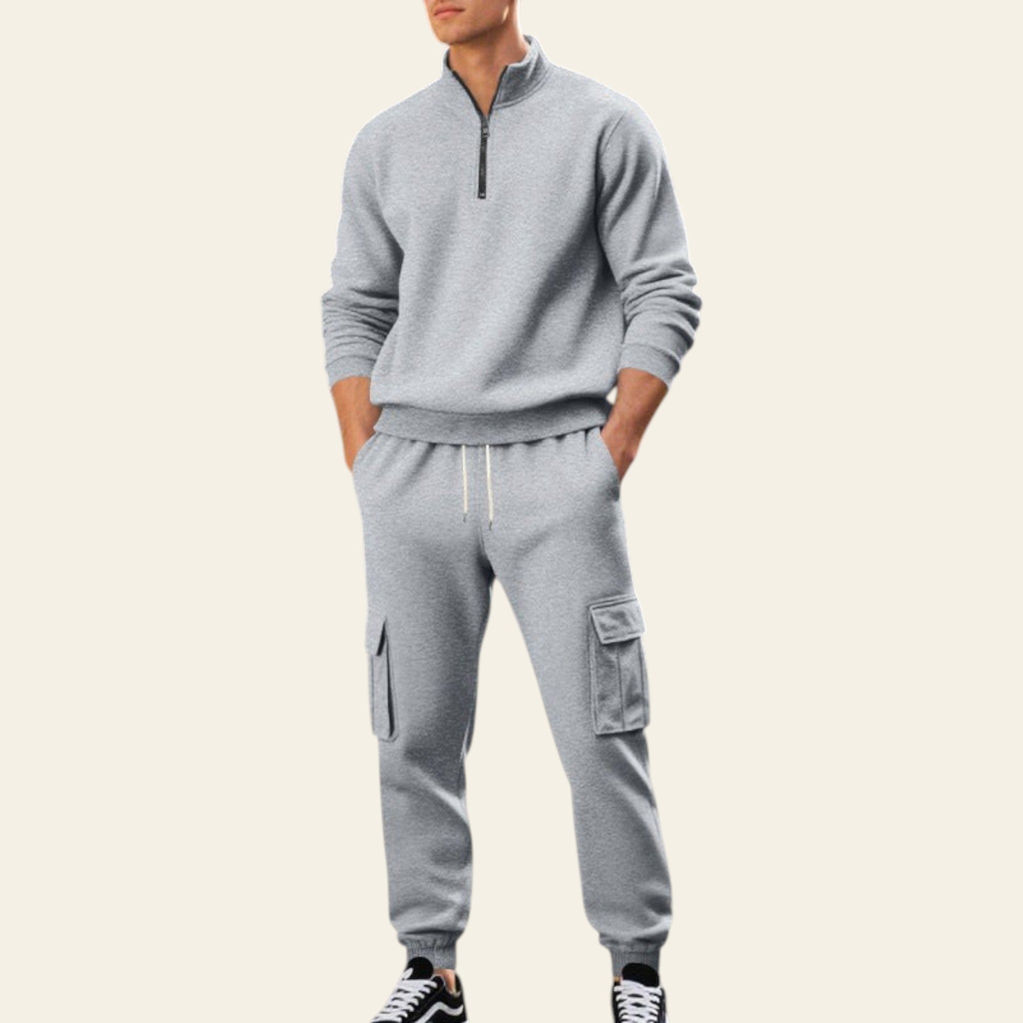 Man wearing a light gray fleece-lined tracksuit set with zip-up jacket and jogger pants on a city street