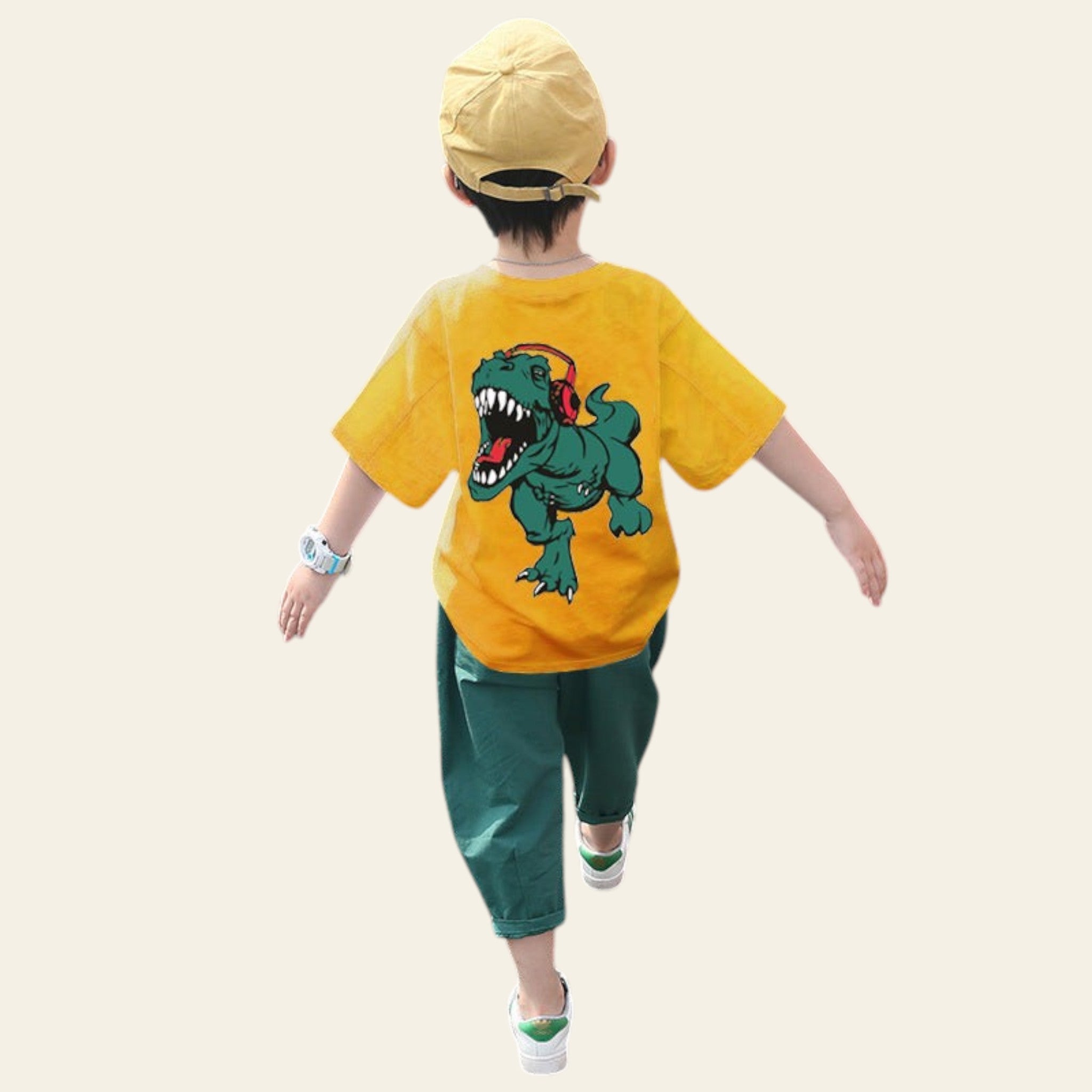 Child wearing a yellow t-shirt with a dinosaur graphic and green pants, walking on a road.