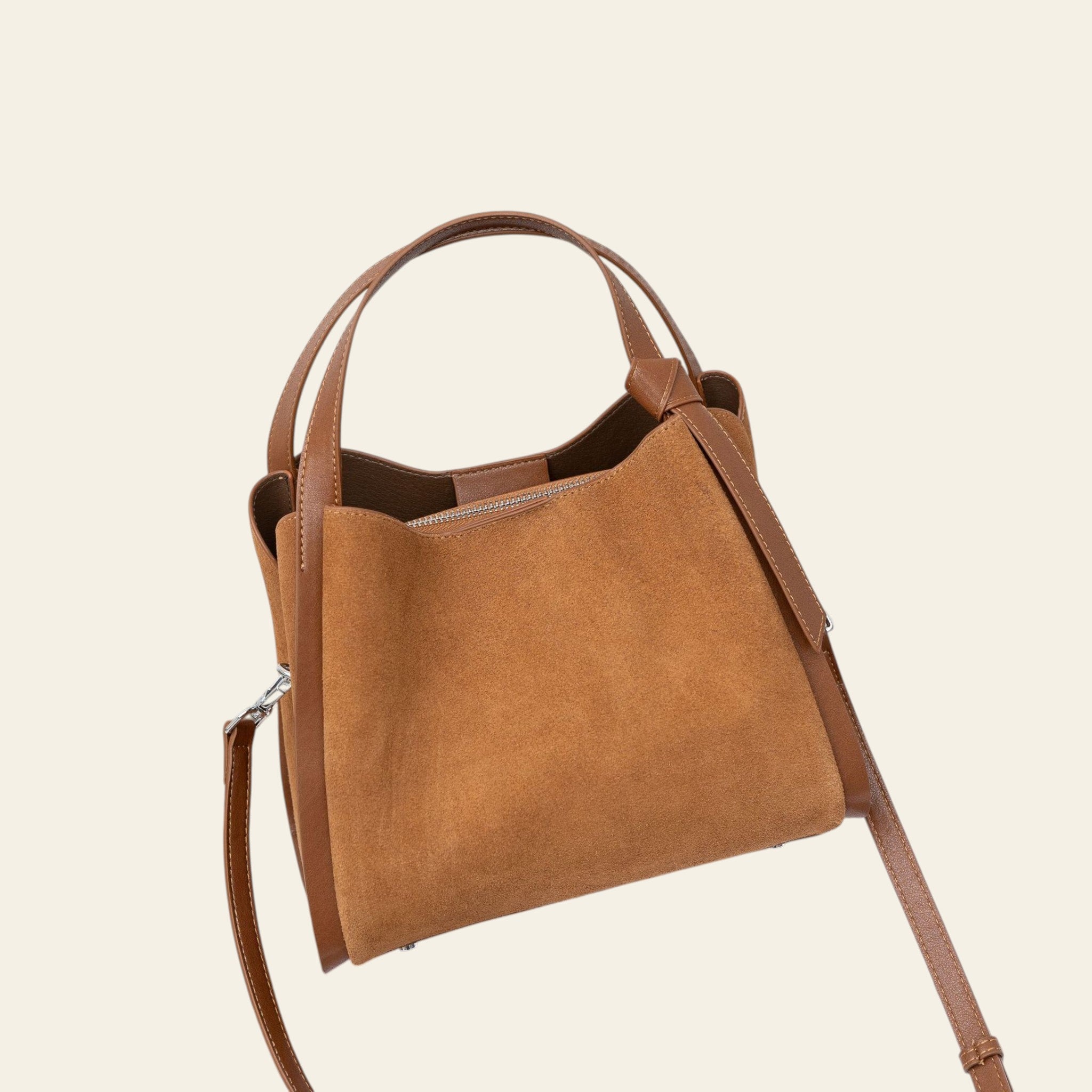 Brown handbag on a magazine with a white background