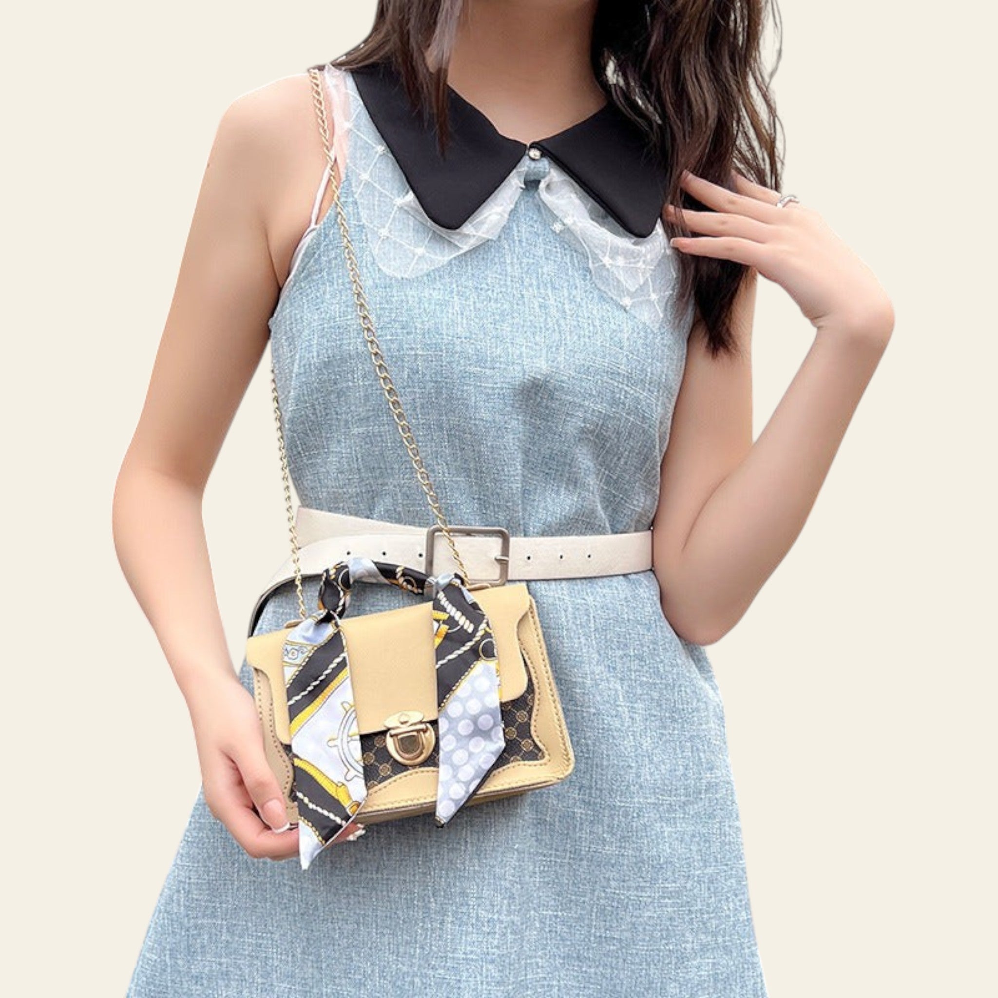 Woman holding a patterned handbag in an outdoor setting