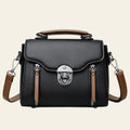 Black handbag with brown straps on a white background