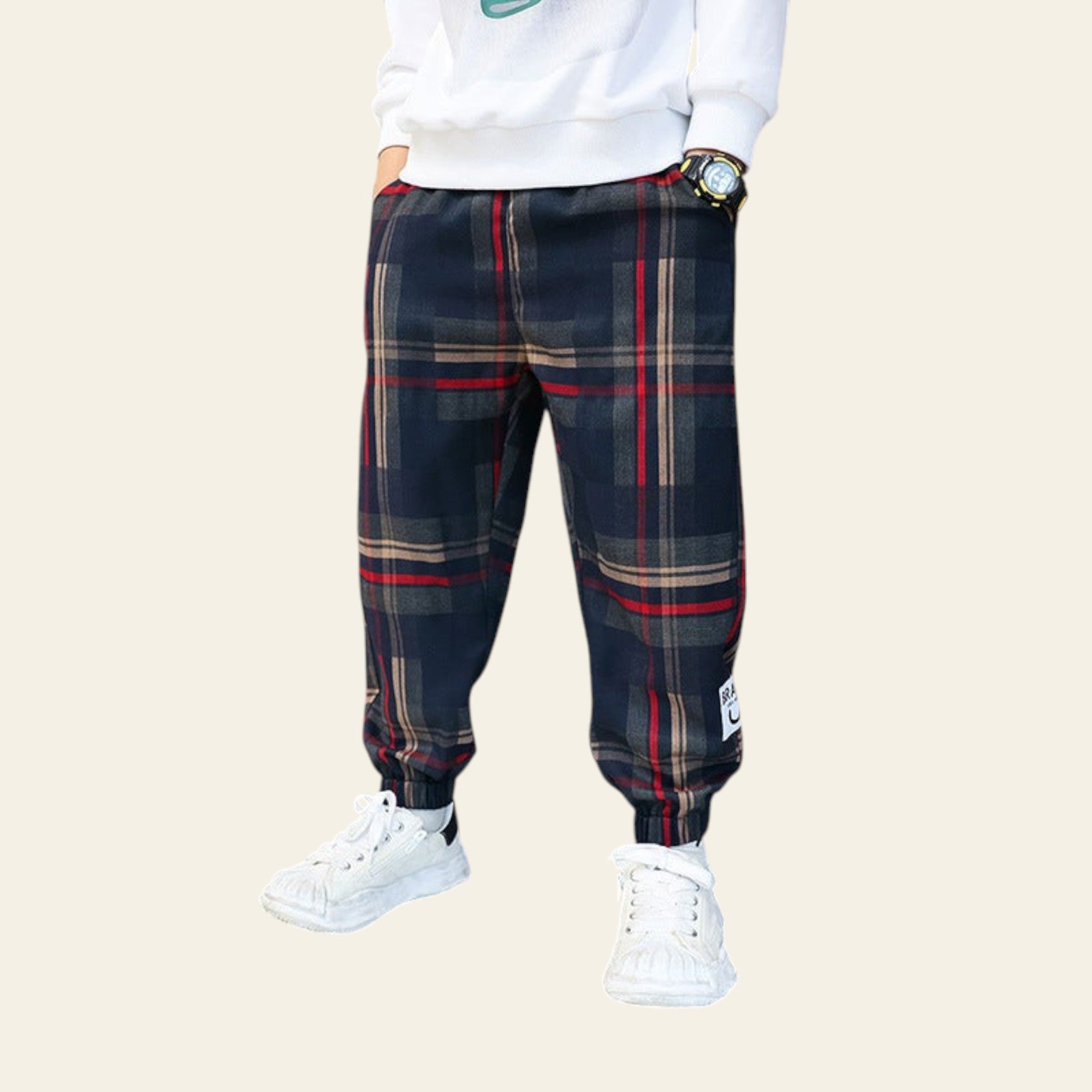 Person wearing plaid pants and white sneakers in a store setting