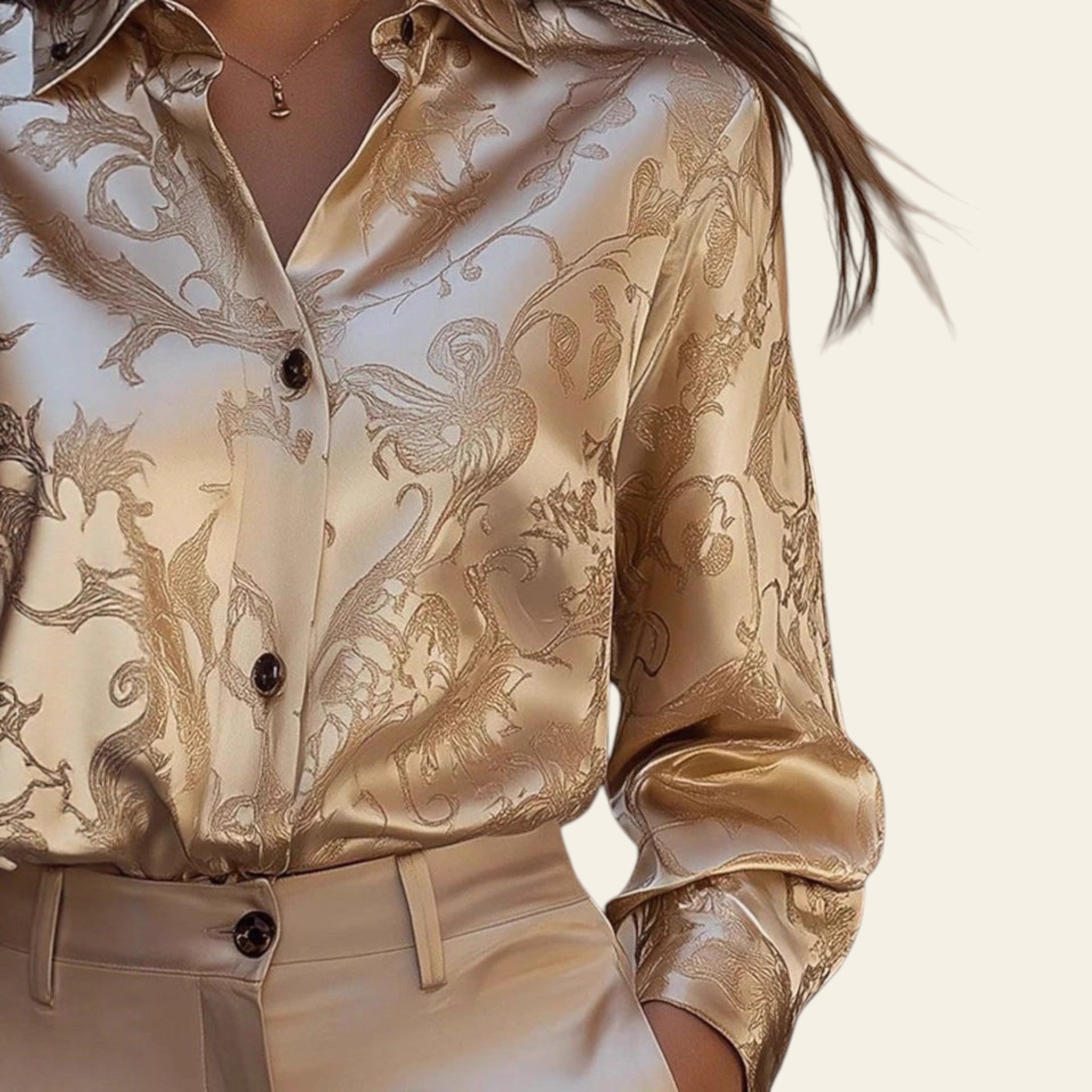 Close-up of a person wearing a gold patterned shirt with blurred background