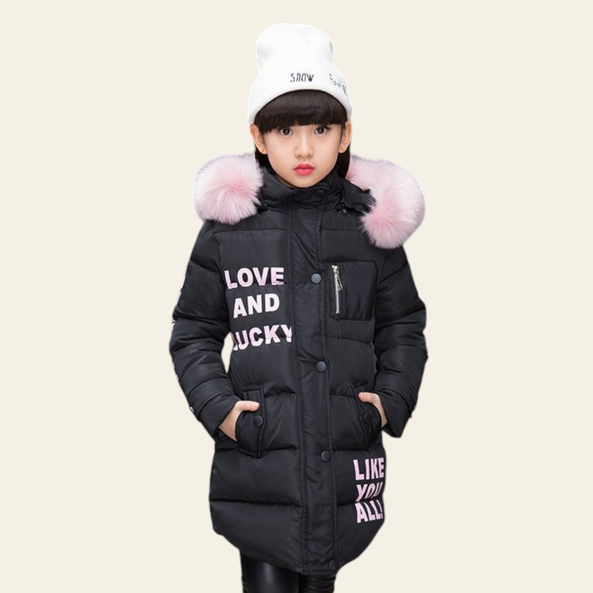 Child wearing a black puffer jacket with pink fur hood against a dark background