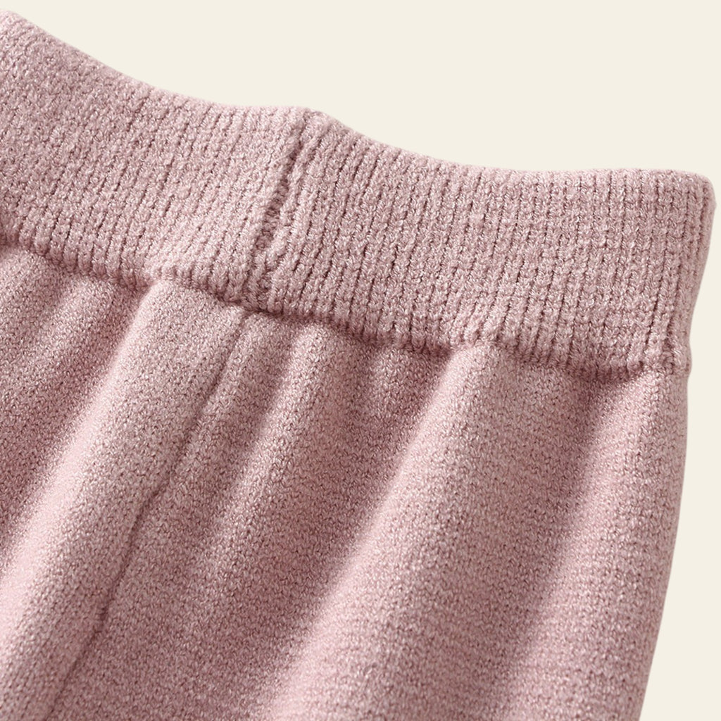 Close-up of pink textured fabric with a white background