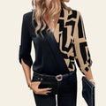 Woman wearing a black blazer with geometric patterned sleeves in an urban setting.