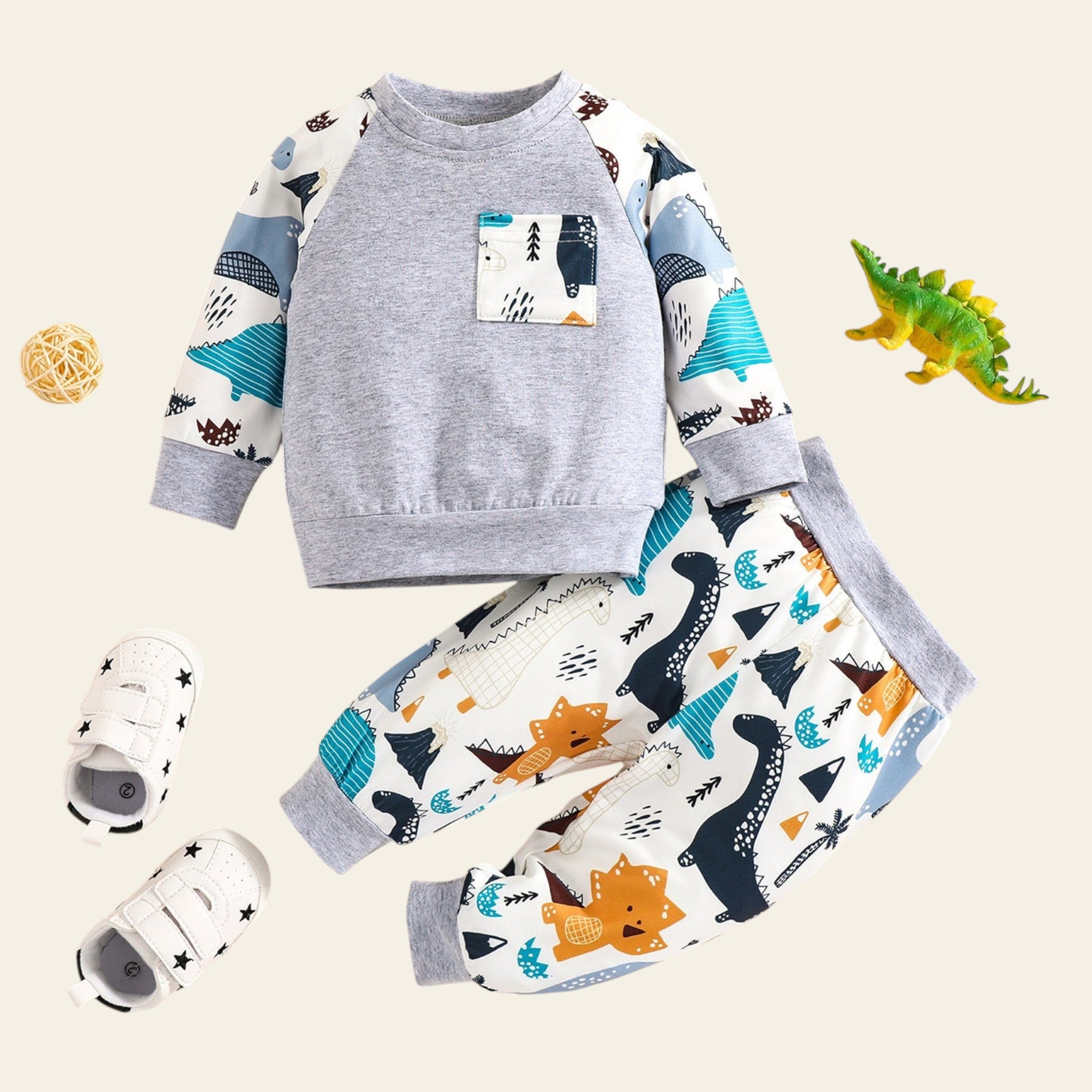 Children's outfit with gray long-sleeve shirt and patterned pants on a beige background