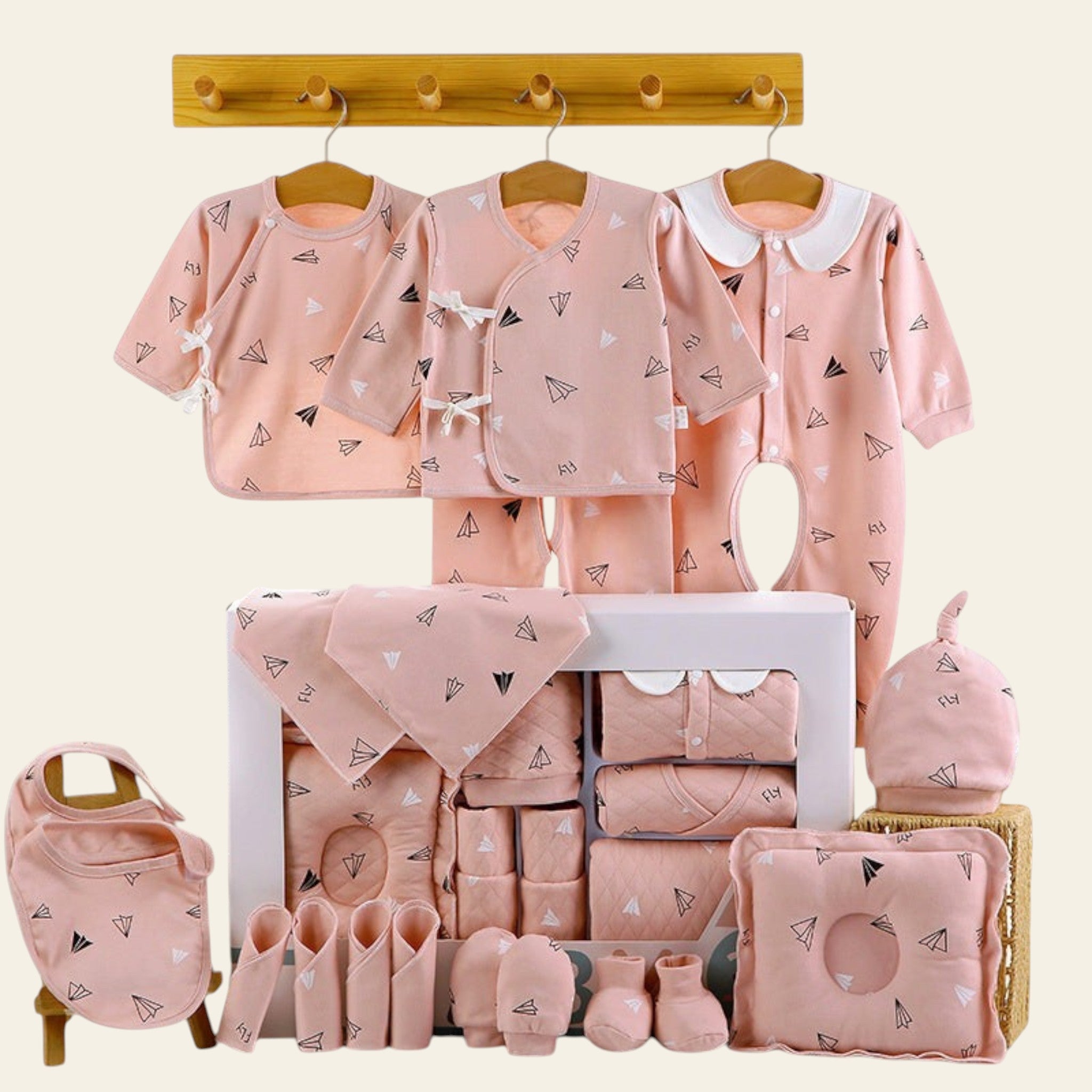 Collection of pink baby clothing and accessories on a white background