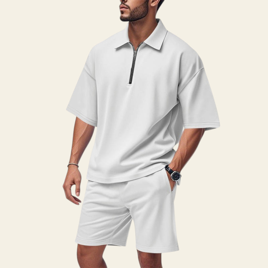 Man wearing a men's summer two-piece set with lapel short sleeve shirt and matching shorts in white color