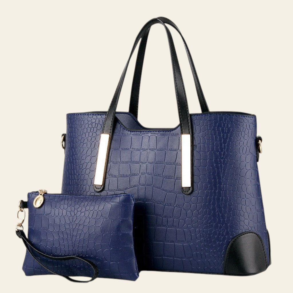 Blue textured handbag with black handles and base, accompanied by a matching pouch on a white background.