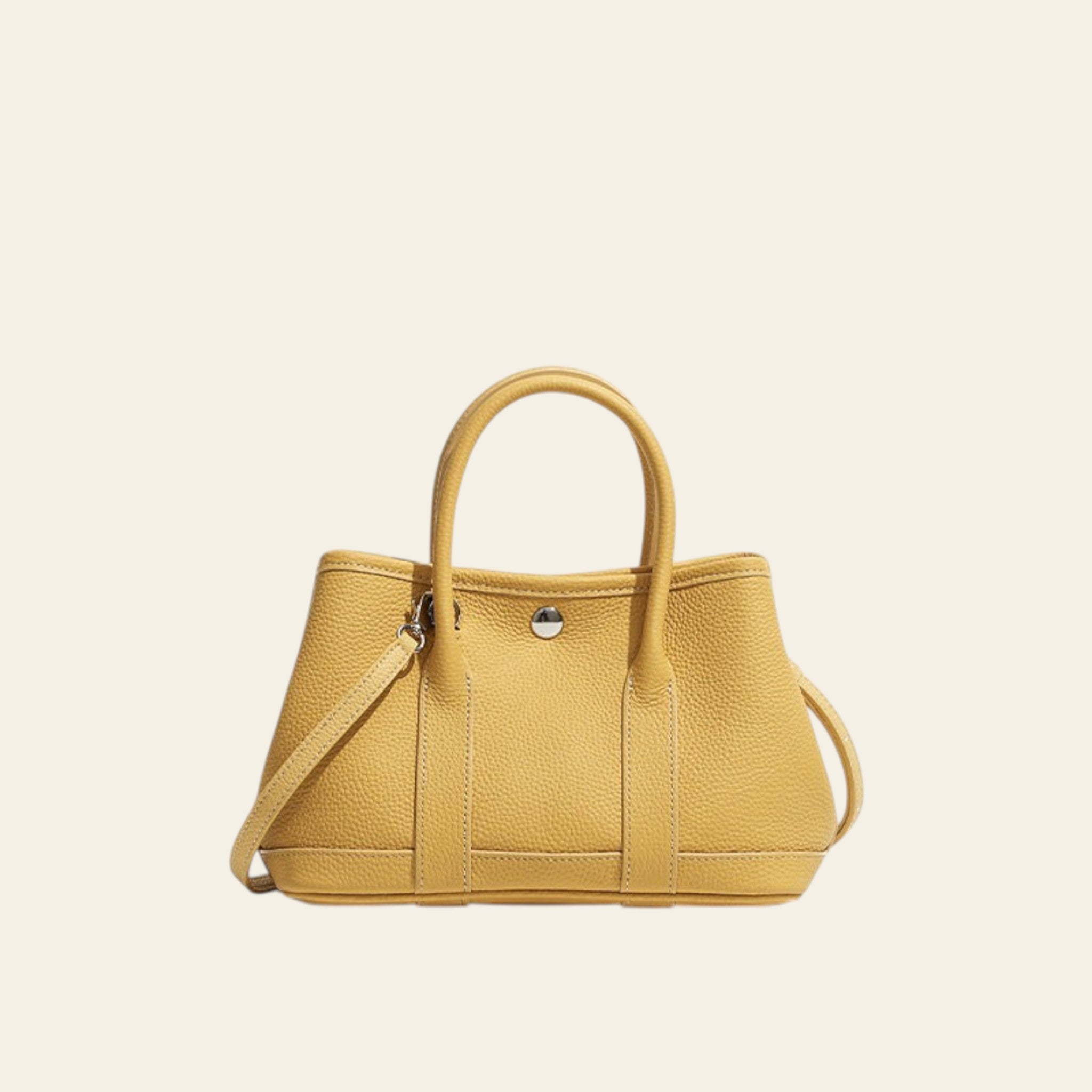 Yellow handbag with a strap on a white background