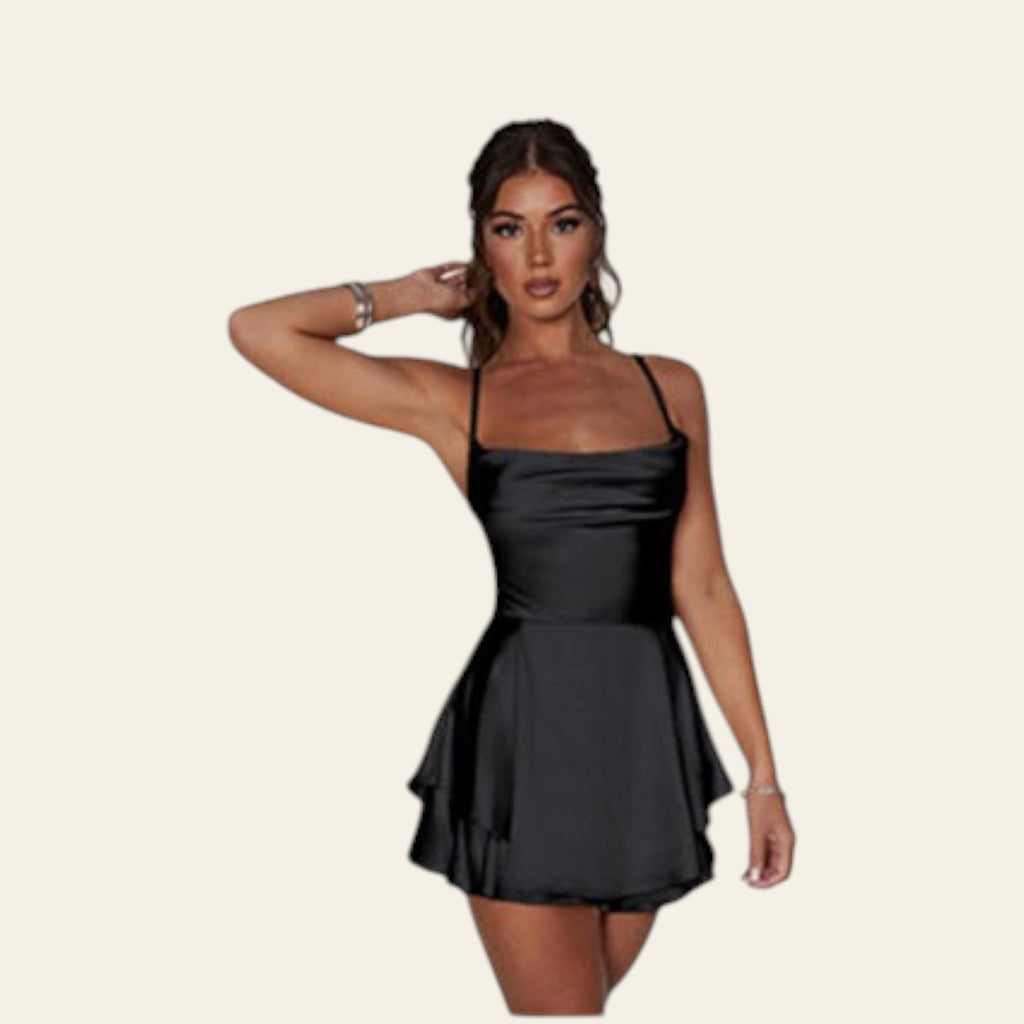 Black dress on a model with a silver bracelet on a white background