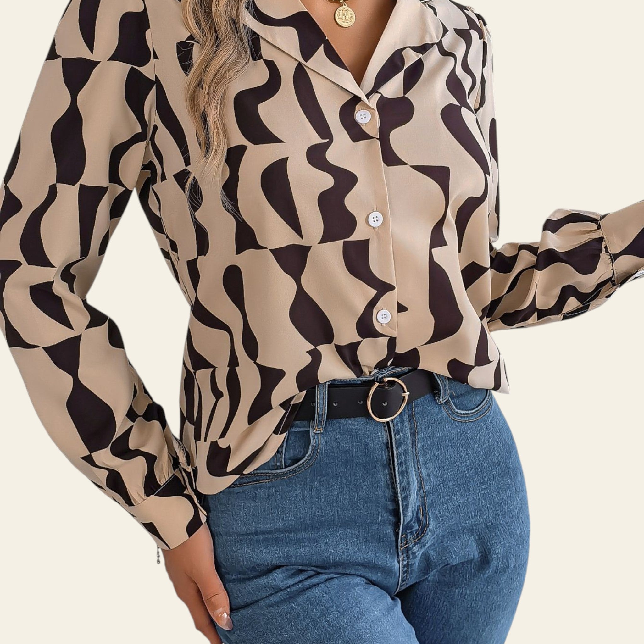 Person wearing a patterned blouse and blue jeans in an indoor setting