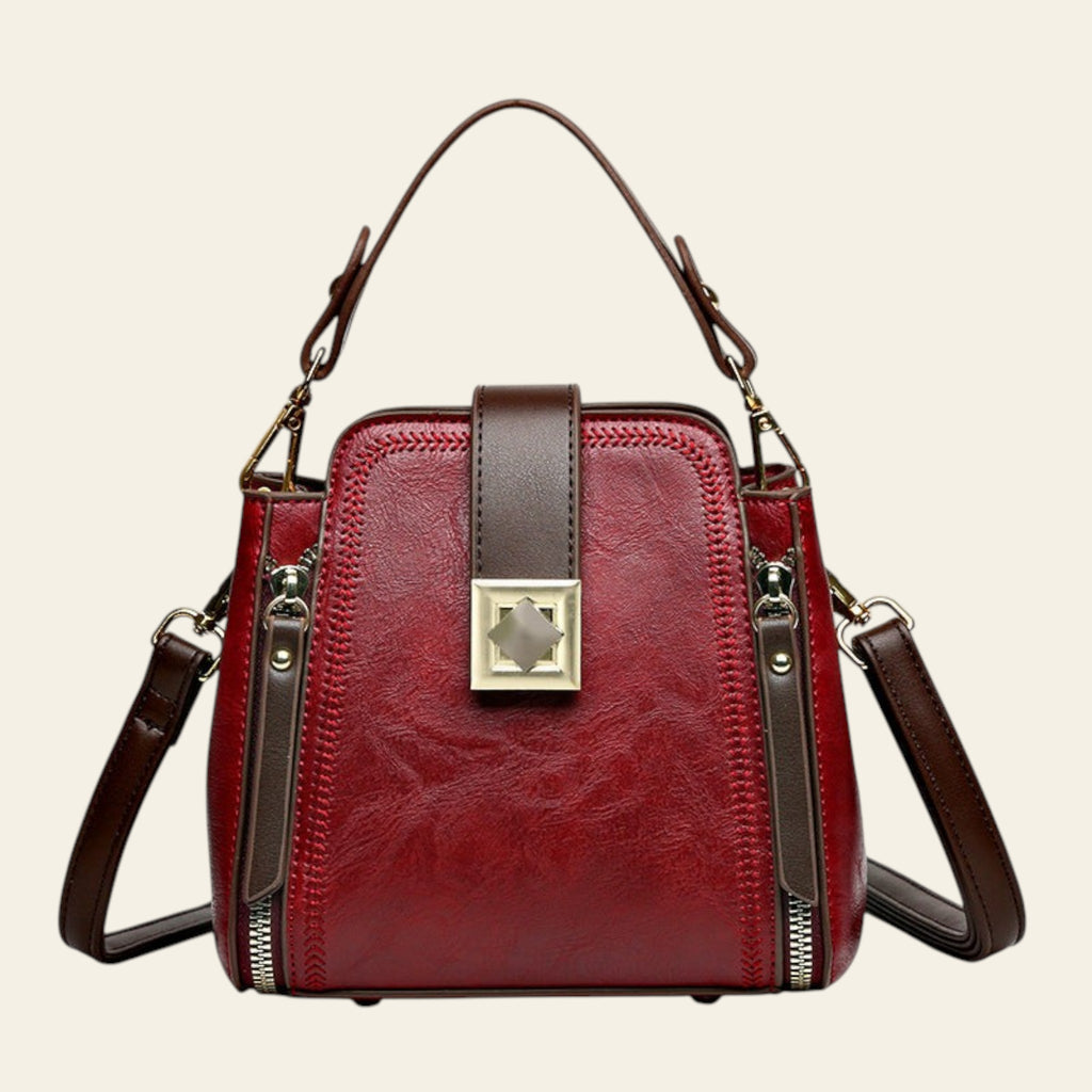 Red handbag with brown accents on a white background