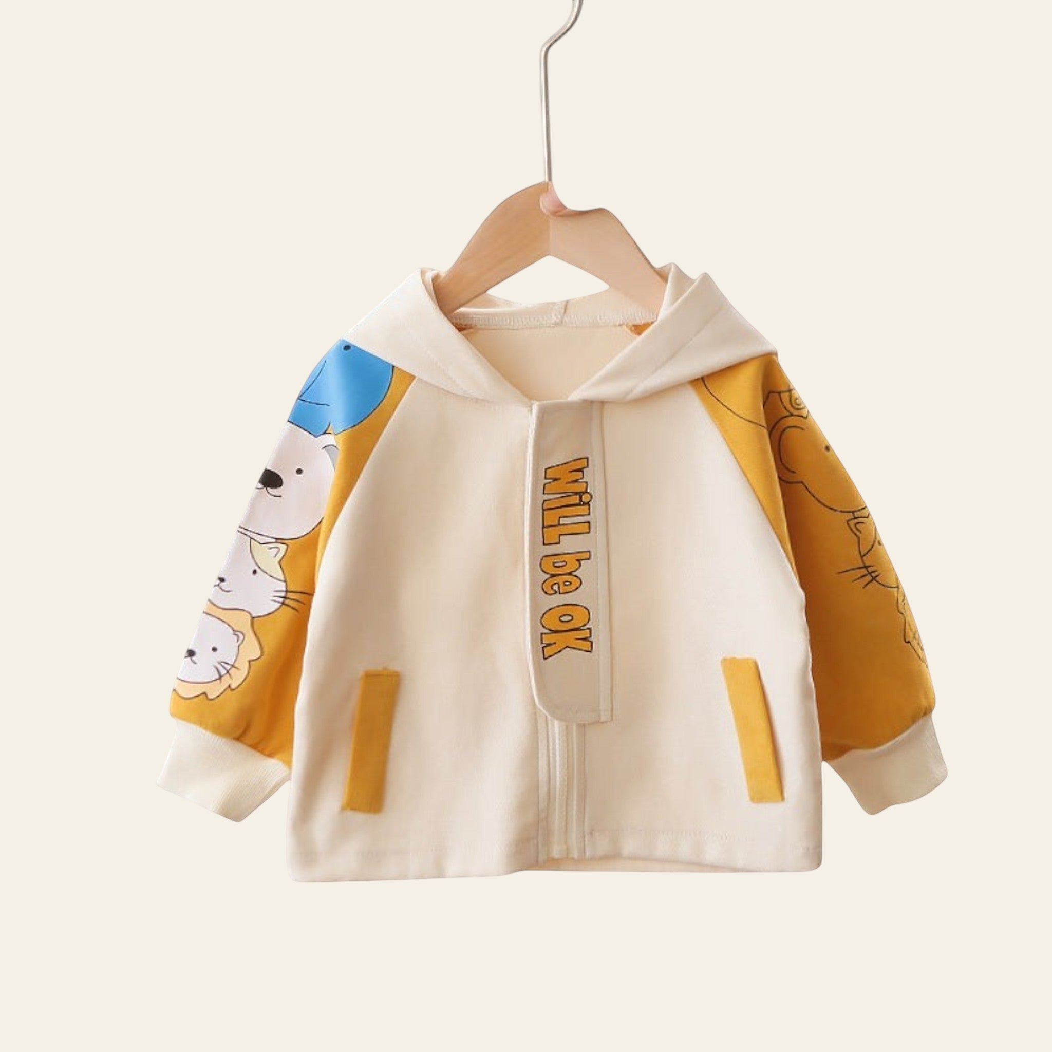 Children's jacket with cartoon designs and text on a hanger against a background of other colorful jackets.